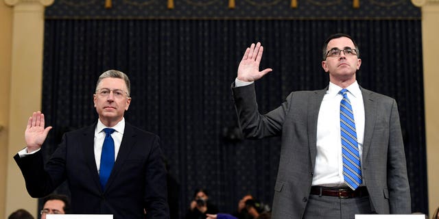 Ambassador Kurt Volker, left, former special envoy to Ukraine, and Tim Morrison, a former official at the National Security Council are sworn in to testify before the House Intelligence Committee on Capitol Hill in Washington, Tuesday, Nov. 19, 2019, during a public impeachment hearing of President Donald Trump's efforts to tie U.S. aid for Ukraine to investigations of his political opponents.(AP Photo/Susan Walsh)