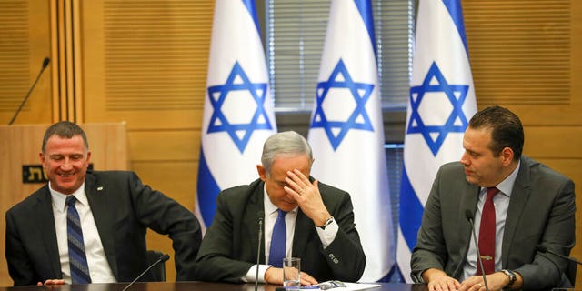 Israeli Prime Minister Benjamin Netanyahu, centre, attends in an extended faction meeting of the right-wing bloc members at the Knesset, in Jerusalem.