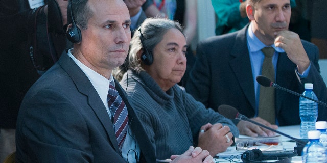 FILE - In this March 22, 2016 file photo, Jose Daniel Ferrer, from left, Juana Mora Cedeno, and Antonio Rodiles, listen during their meeting with President Barack Obama at the U.S. Embassy, in Havana, Cuba. (AP Photo/Pablo Martinez Monsivais, File)