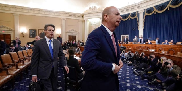 U.S. Ambassador to the European Union Gordon Sondland, followed at left by attorney James McDermott, finishes a day of testimony before the House Intelligence Committee on Capitol Hill in Washington, Wednesday, Nov. 20, 2019, during a public impeachment hearing of President Donald Trump's efforts to tie U.S. aid for Ukraine to investigations of his political opponents. (AP Photo/J. Scott Applewhite)