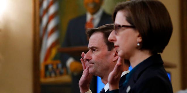 Deputy Assistant Secretary of Defense Laura Cooper, right, and State Department official David Hale, are sworn in to testify before the House Intelligence Committee on Capitol Hill. (AP Photo/Alex Brandon)
