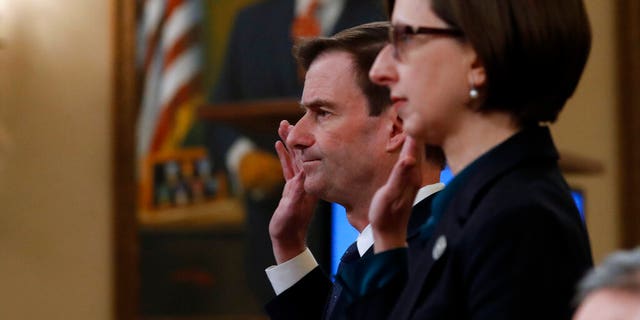 Deputy Assistant Secretary of Defense Laura Cooper, right, and State Department official David Hale, are sworn in to testify before the House Intelligence Committee on Capitol Hill. (AP Photo/Alex Brandon)