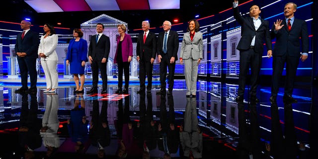 Democratic presidential candidates from left, Sen. Cory Booker, D-N.J., Rep. Tulsi Gabbard, D-Hawaii, Sen. Amy Klobuchar, D-Minn., South Bend, Ind., Mayor Pete Buttigieg, Sen. Elizabeth Warren, D-Mass., former Vice President Joe Biden, Sen. Bernie Sanders, I-Vt., Sen. Kamala Harris, D-Calif., former technology executive Andrew Yang and investor Tom Steyer wave to the audience before a Democratic presidential primary debate, Wednesday, Nov. 20, 2019, in Atlanta. (AP Photo/John Amis)