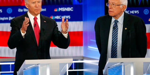 Democratic presidential candidate former Vice President Joe Biden, speaks as Democratic presidential candidate Sen. Bernie Sanders, I-Vt., listens during a Democratic presidential primary debate, Wednesday, Nov. 20, 2019, in Atlanta. (AP Photo/John Bazemore)