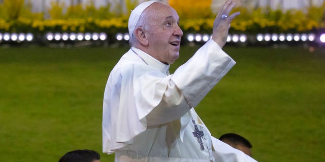 Pope Francis greets the faithful from his "popemobile" as he arrives for Mass in Bangkok on Thursday.