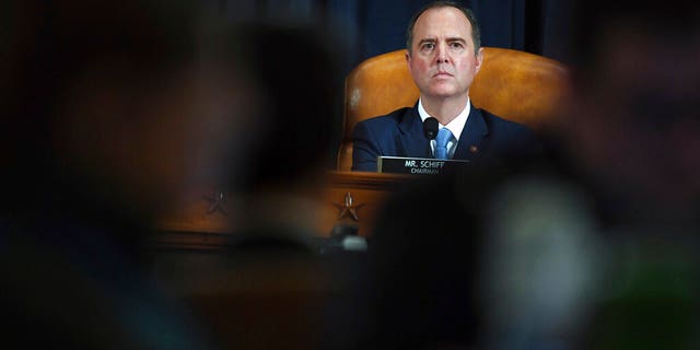 House Intelligence Committee Chairman Adam Schiff, D-Calif., listen to former White House national security aide Fiona Hill and David Holmes, a U.S. diplomat in Ukraine, during testimony before the House Intelligence Committee on Capitol Hill in Washington, Thursday, Nov. 21, 2019, during a public impeachment hearing of President Donald Trump's efforts to tie U.S. aid for Ukraine to investigations of his political opponents. (Matt McCain/Pool Photo via AP)