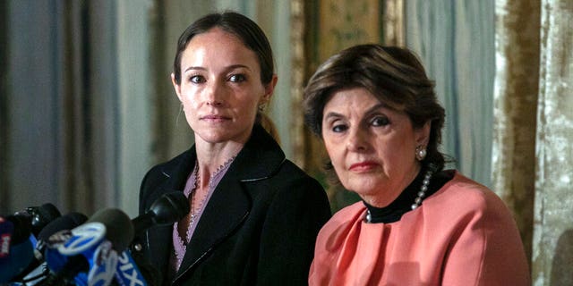 Teala Davies, left, and attorney Gloria Allred, right, at a news conference about the filing of a lawsuit against the estate of Jeffrey Epstein. Davies said she was 17 when he victimized her. (AP Photo/Jeenah Moon)