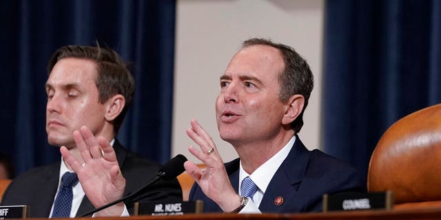 House Intelligence Committee Chairman Adam Schiff, D-Calif., with committee staffer Daniel Noble at left, makes impassioned remarks at the conclusion of a week of public impeachment hearings on President Donald Trump's efforts to tie U.S. aid for Ukraine to investigations of his political opponents, on Capitol Hill in Washington, Thursday, Nov. 21, 2019. Schiff sent out a fundraising email following Rep. Liz Cheney's ouster from House leadership on May 12, 2021. (AP Photo/J. Scott Applewhite)