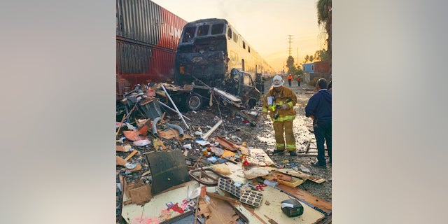 This photo provided by the Norwalk Sheriff's Station shows first responders at the scene after an RV was hit by a commuter train in Santa Fe Springs, Calif., on Friday. (Norwalk Sheriff's Station via AP)