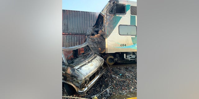 This photo provided by the Norwalk Sheriff's Station shows the scene after an RV was hit by a commuter train and burst into flames along a track in Santa Fe Springs, Calif. on Friday. Authorities say the collision occurred shortly after 5:30 a.m. Friday at an intersection in an industrial area of Santa Fe Springs. There were no immediate reports of injuries. All passengers on the Metrolink train were safely evacuated. (Norwalk Sheriff's Station via AP)