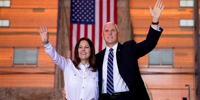 Former Vice President Mike Pence and his wife Karen Pence wave as they take the stage to speak to troops at Al Asad Air Base, Iraq, Saturday, Nov. 23, 2019. The visit is Pence’s first to Iraq and comes nearly one year since President Donald Trump’s surprise visit to the country.