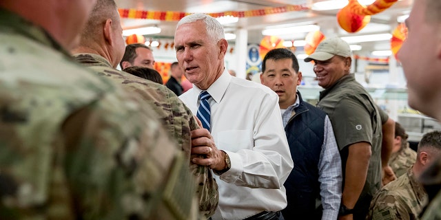 Vice President Mike Pence greets troops at a mess hall at Al Asad Air Base, Iraq, Saturday, Nov. 23, 2019. (AP Photo/Andrew Harnik)
