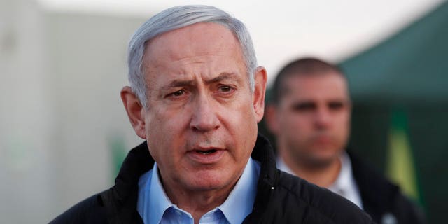 Israeli Prime Minister Benjamin Netanyahu visits an Israeli army base in the Golan Heights, on the Israeli-Syrian border, Sunday, Nov. 24, 2019. (Atef Safadi/Pool via AP)