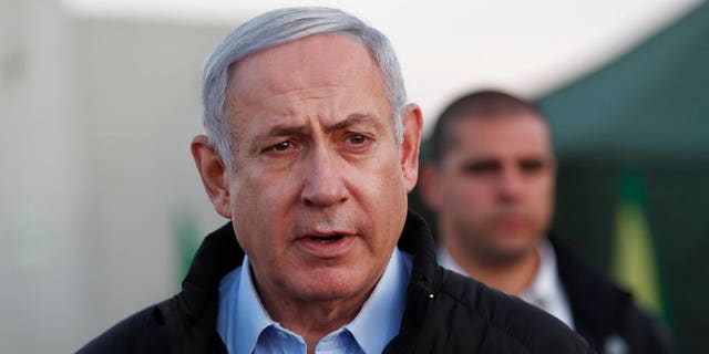 Israeli Prime Minister Benjamin Netanyahu visits an Israeli army base in the Golan Heights, on the Israeli-Syrian border, Sunday, Nov. 24, 2019. (Atef Safadi/Pool via AP)