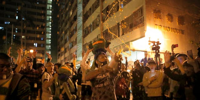 Pro-democracy supporters celebrating after pro-Beijing politician Junius Ho lost his election in Hong Kong, early Monday. (AP Photo/Kin Cheung)