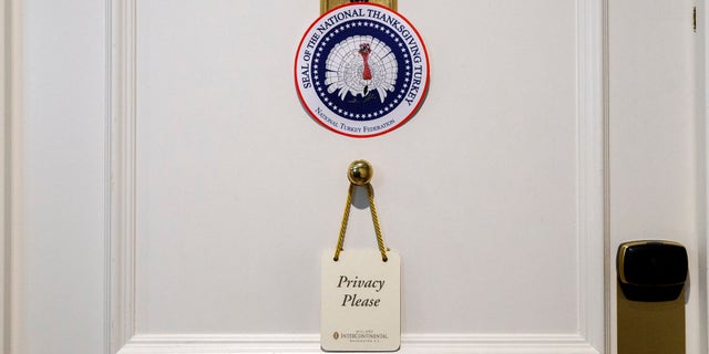 A door has a privacy request hanging on it outside the hotel room where two turkeys that will be pardoned by President Donald Trump are staying at the Willard InterContinental Hotel, Monday, Nov. 25, 2019, in Washington. The turkeys will be pardoned by the president during a ceremony at the White House ahead of Thanksgiving. (AP Photo/Jacquelyn Martin)