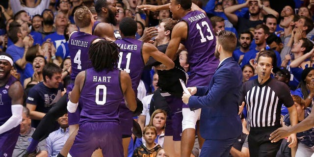 Stephen F. Austin players celebrate the team's 85-83 overtime win over Duke in an NCAA college basketball game in Durham, N.C.