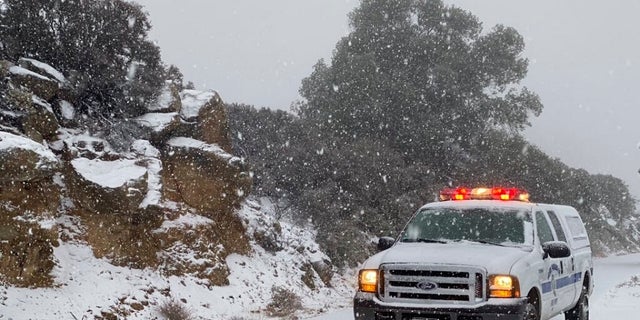  This image tweeted by the Santa Barbara County Fire Department shows a Santa Barbara Fire Department truck along E. Camino Cielo as snow falls at the 3,500 foot level on the fire footprint in Santa Barbara, Calif. Thursday&, Nov. 28, 2019. Wintry weather condition temporarily loosened its grip across much of the U.S. in the nick of time for Thanksgiving, after tangling holiday tourists in ice, snow and wind and prior to more significant storms come down Friday.( Mike Eliason/Santa Barbara County Fire through AP)