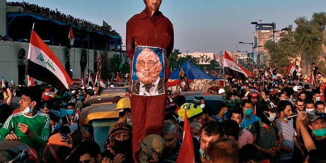  In this Wednesday, Oct. 30, 2019 file photoPicture anti-government protesters hold an effigy of Iraqi Prime Minister Adel Abdel-Mahdi during throughout continuous demonstrations Baghdad.( AP Photo/Khalid Mohammed, File)