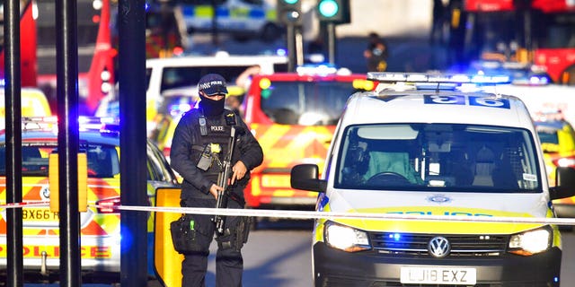 Armed police guard the scene of an incident on London Bridge. (Dominic Lipinski/PA via AP)