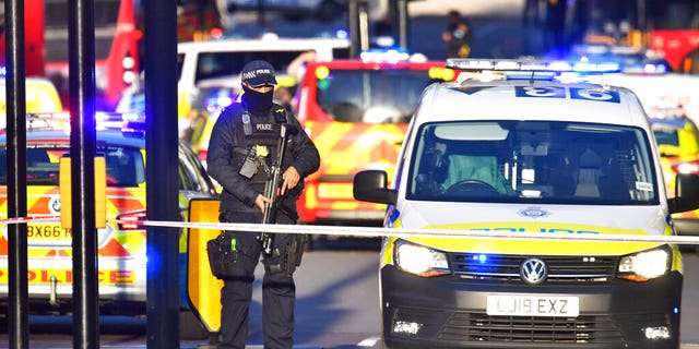 Armed police guard the scene of an incident on London Bridge. (Dominic Lipinski/PA via AP)