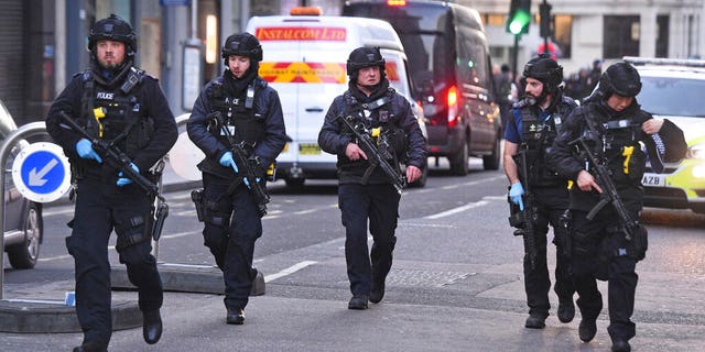 Police on Cannon Street in London near the scene of an incident on London Bridge on Friday. (Kirsty O'Connor/PA via AP)