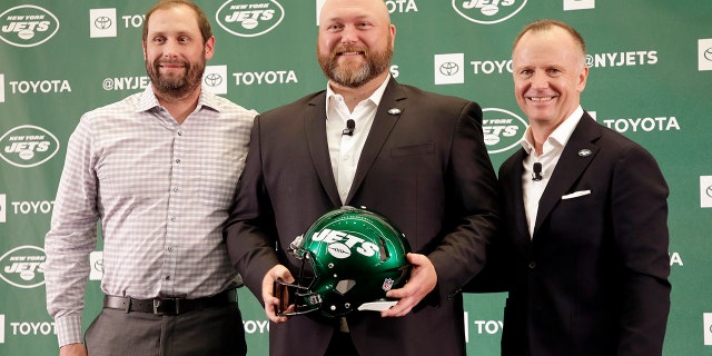 FILE - In this June 11, 2019, file photo, New New York Jets general manager Joe Douglas, center, poses for a picture with head coach Adam Gase, left, and Jets chairman and CEO Christopher Johnson during a news conference at the team's NFL football training facility in Florham Park, N.J. (AP Photo/Seth Wenig, File)
