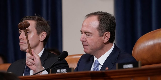 House Intelligence Committee Chairman Adam Schiff, D-Calif., with committee staffer Daniel Noble at left, concludes a week of public impeachment hearings on President Donald Trump's efforts to tie U.S. aid for Ukraine to investigations of his political opponents.