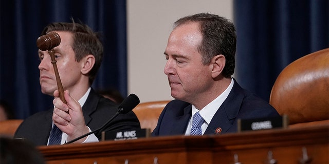 House Intelligence Committee Chairman Adam Schiff, D-Calif., with committee staffer Daniel Noble at left, concludes a week of public impeachment hearings on President Donald Trump's efforts to tie U.S. aid for Ukraine to investigations of his political opponents.