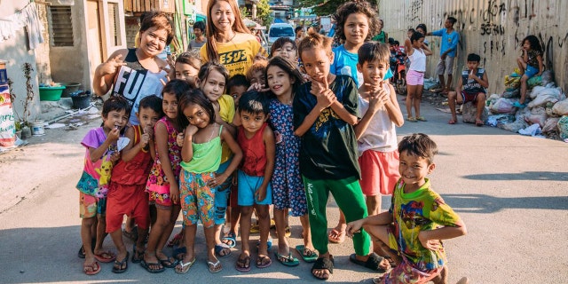 Angelica Echivarre with kids participating in the Compassion program she teaches in.