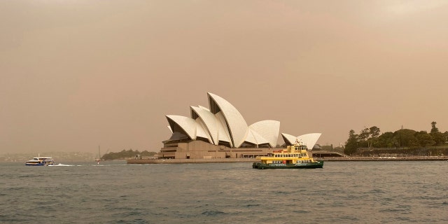 Sydney Opera House is backdropped by haze from wildfires near the city, in Sydney, Australia, Tuesday Nov. 12, 2019.