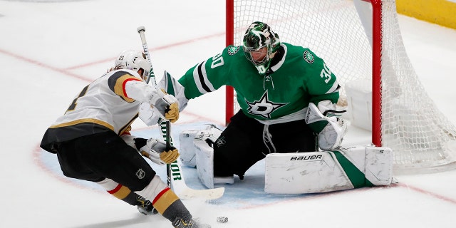 Dallas Stars goaltender Ben Bishop (30) makes a save against a shot from Vegas Golden Knights center Cody Eakin (21) in the third period of an NHL hockey game in Dallas, Monday, Nov. 25, 2019. (AP Photo/Tony Gutierrez)