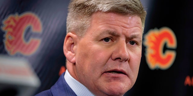 FILE - In this April 23, 2018, file photo, new Calgary Flames NHL hockey team head coach Bill Peters speaks to the media in Calgary, Alberta. (Jeff McIntosh/The Canadian Press via AP, File)