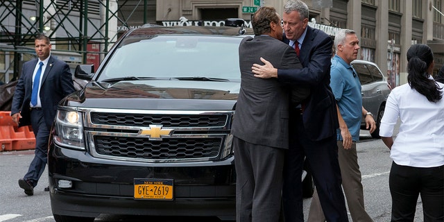 New York Gov. Andrew Cuomo, left, and Mayor Bill de Blasio embrace as they arrive near the scene of an explosion on West 23rd street in Manhattan's Chelsea neighborhood, in New York, Sunday, Sept. 18, 2016, after an incident that injured passers-by Saturday evening. (AP Photo/Craig Ruttle)