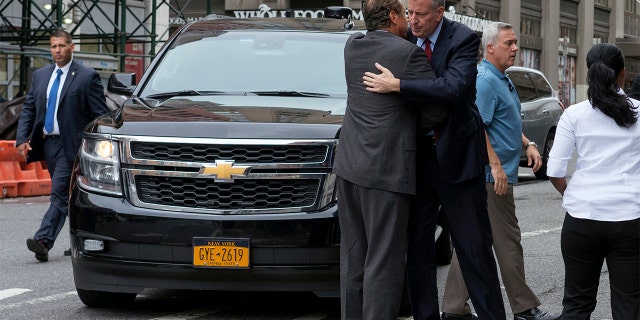 New York Gov. Andrew Cuomo, left, and Mayor Bill de Blasio embrace as they arrive near the scene of an explosion on West 23rd street in Manhattan's Chelsea neighborhood, in New York, Sunday, Sept. 18, 2016, after an incident that injured passers-by Saturday evening. (AP Photo/Craig Ruttle)