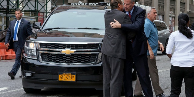 New York Gov. Andrew Cuomo, left, and Mayor Bill de Blasio embrace as they arrive near the scene of an explosion on West 23rd street in Manhattan's Chelsea neighborhood, in New York, Sunday, Sept. 18, 2016, after an incident that injured passers-by Saturday evening. (AP Photo/Craig Ruttle)