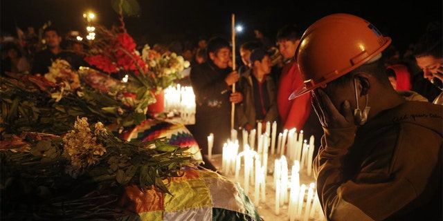 Mourners gather around coffins of backers of former President Evo Morales killed during clashes with security forces in Sacaba, Bolivia, Friday, Nov. 15, 2019. Bolivian security forces clashed with Morales' backers leaving at least five people dead, dozens more injured and escalating the challenge to the country's interim government to restore stability. (AP Photo/Juan Karita)