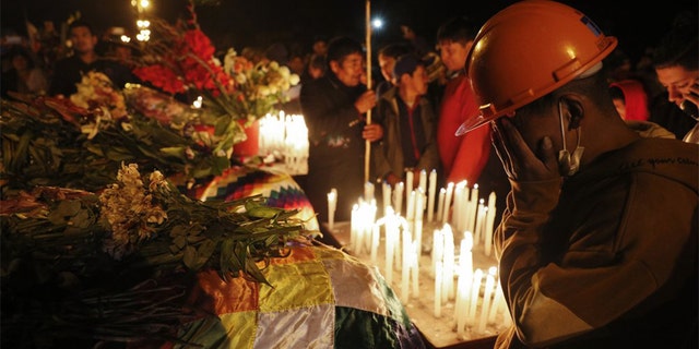 Mourners gather around coffins of backers of former President Evo Morales killed during clashes with security forces in Sacaba, Bolivia, Friday, Nov. 15, 2019. Bolivian security forces clashed with Morales' backers leaving at least five people dead, dozens more injured and escalating the challenge to the country's interim government to restore stability. (AP Photo/Juan Karita)