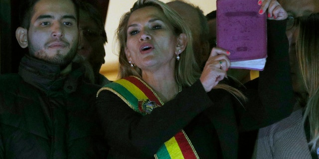 Opposition politician Jeanine Anez addresses the crowd from the balcony of the Quemado palace in La Paz after she declared herself interim president of Bolivia Tuesday. (AP Photo/Juan Karita)