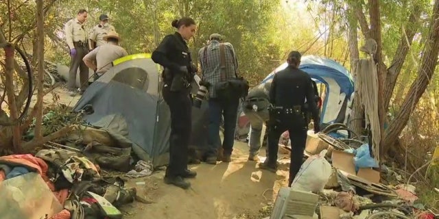Crews work to dismantle homeless encampment in the Sepulveda Basin Wildlife Reserve on Monday.