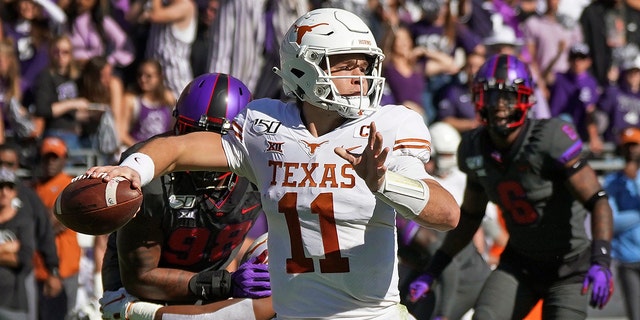 Texas quarterback Sam Ehlinger (11) throws a pass in the first half of an NCAA college football game against TCU in Fort Worth, Texas, Saturday, Oct. 26, 2019.
