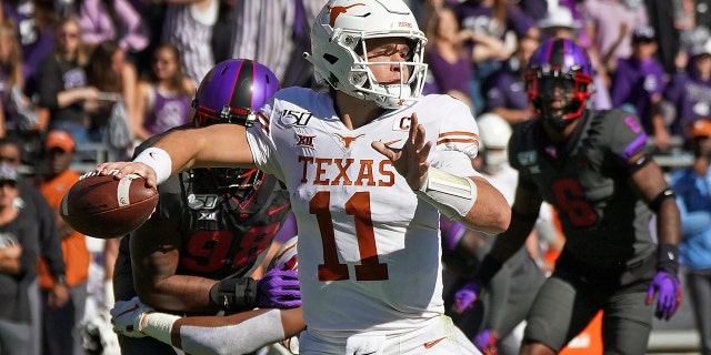 Texas quarterback Sam Ehlinger (11) throws a pass in the first half of an NCAA college football game against TCU in Fort Worth, Texas, Saturday, Oct. 26, 2019.