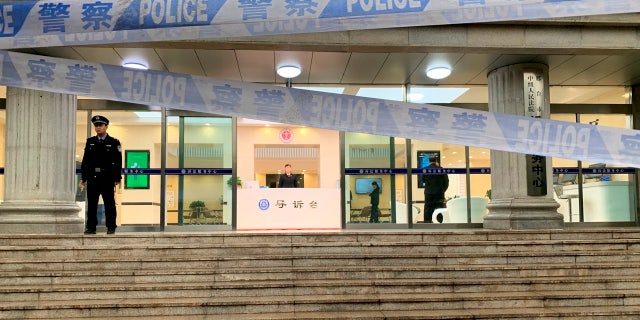 Police stand guard outside the Xingtai Intermediate People's court in Xingtai county, north China's Hebei province Thursday, Nov. 7, 2019.