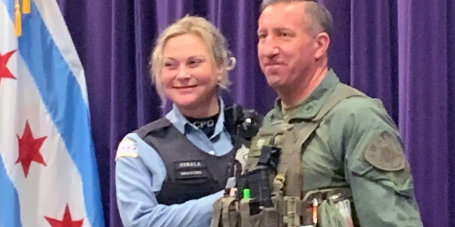 Chicago Police Officer Erin Gubala with SWAT Sgt. Mike Nowacki got engaged Sunday after Nowacki ran the Hot Chocolate 15k in full gear and reviving another runner.