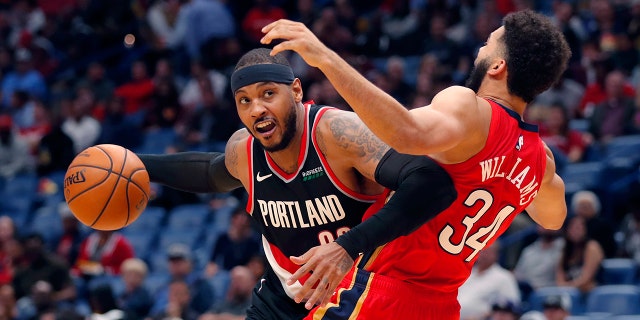 Portland Trail Blazers forward Carmelo Anthony is defended by New Orleans Pelicans guard Kenrich Williams (34) during the second half of an NBA basketball game in New Orleans, Tuesday, Nov. 19, 2019. The Pelicans won 115-104. (AP Photo/Gerald Herbert)