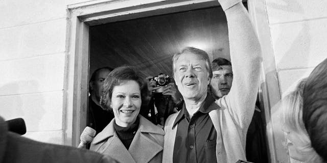 Democratic presidential candidate Jimmy Carter and his wife, Rosalynn, depart the Plains, Ga., polling place, Nov. 2, 1976. The candidate was the fifth person to vote in his precinct. (AP Photo)