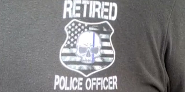 Vincent Champion was wearing a T-shirt that read “Retired Police Officer” on the front, but Universal said it has a policy against allowing anyone inside with a shirt that might identify them as emergency personnel.