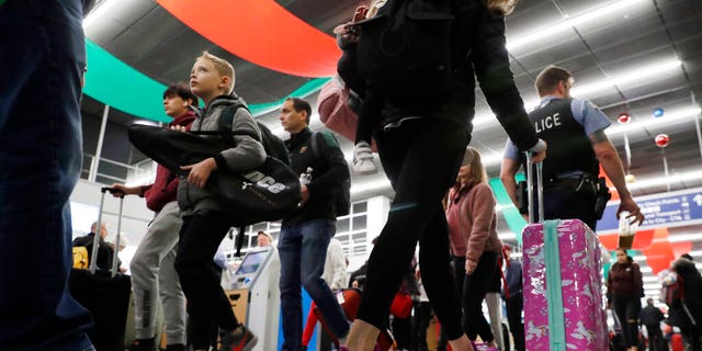 Travelers are seen passing through Chicago's O'Hare International Airport amid one of the busiest travel periods of the year.