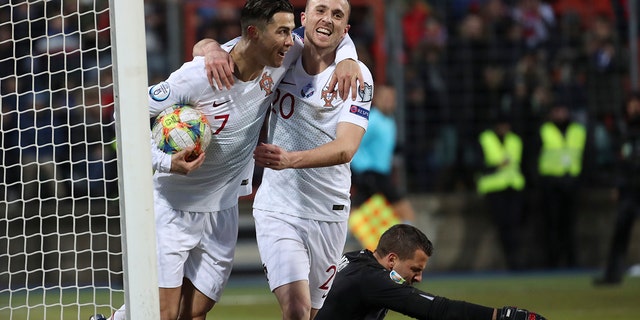 Portugal's Cristiano Ronaldo, left, celebrates with his teammate Diogo Jota after he scored his side's second goal during the Euro 2020 group B qualifying soccer match between Luxembourg and Portugal at the Josy Barthel stadium in Luxembourg, Sunday, Nov. 17, 2019. (AP Photo/Francisco Seco)