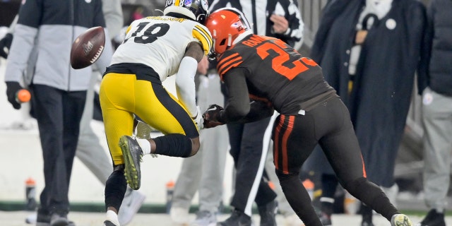 Cleveland Browns strong safety Damarious Randall (23) hits Pittsburgh Steelers wide receiver Diontae Johnson (18) during the second half of an NFL football game Thursday, Nov. 14, 2019, in Cleveland. Randall was called for unnecessary roughness and was ejected.